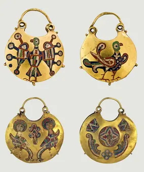 Four decorative gold pendants, each featuring intricate designs. The top left shows a stylized bird with colorful patterns, while the top right depicts a bird sitting beside a smaller one. The bottom left features two figures with crosses and floral motifs, and the bottom right displays geometric and floral designs.