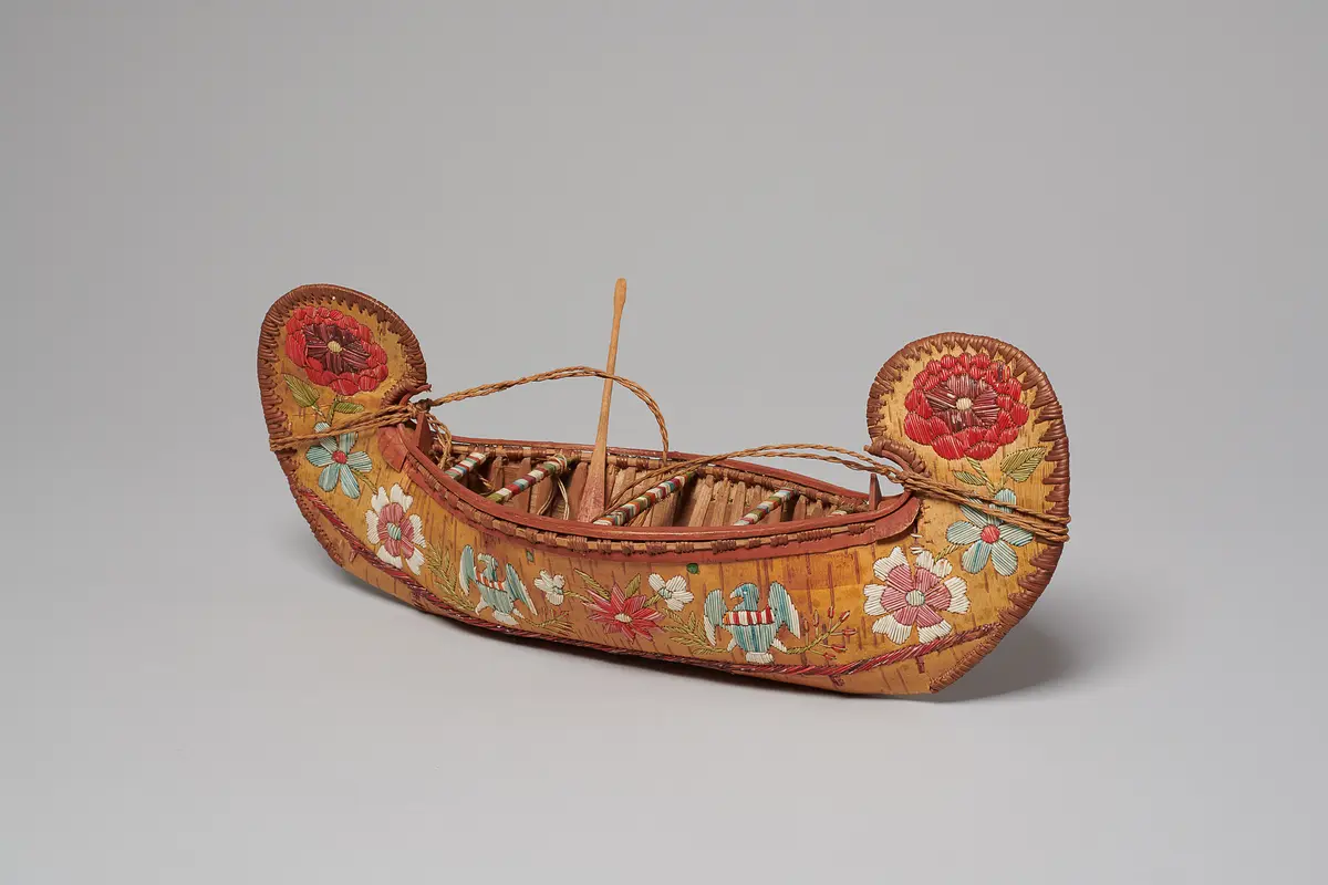 Model canoe with flowers and U.S. eagles