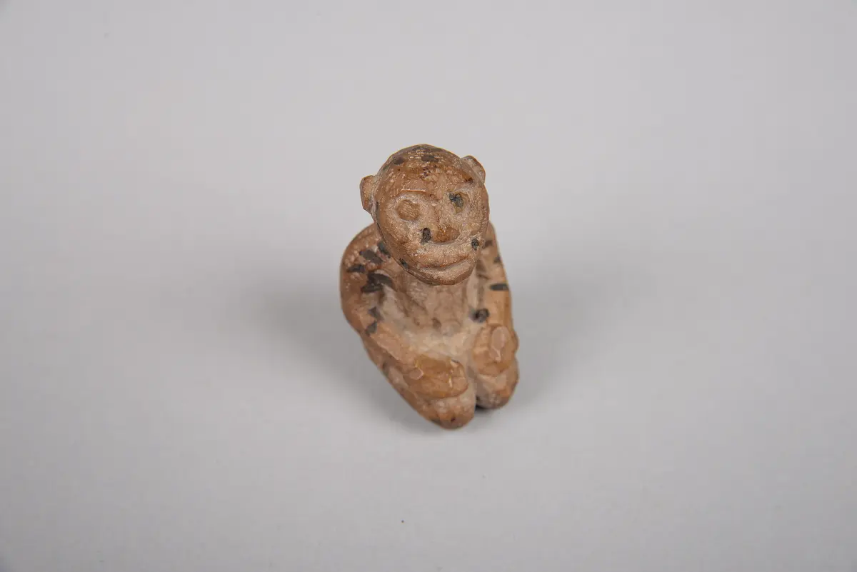 Knieende Figur