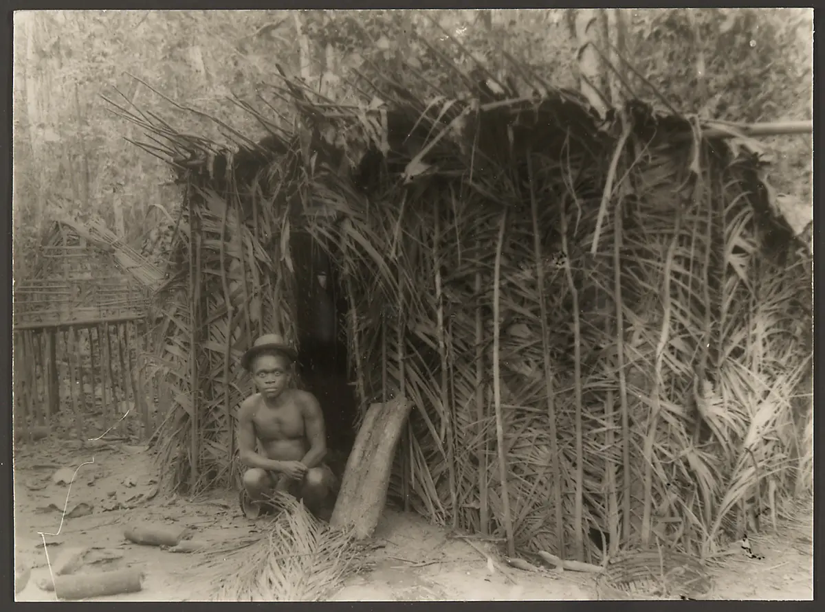 Man sitting before a house
