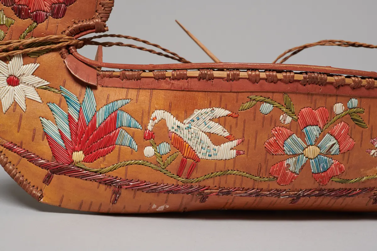 Model canoe with flowers and U.S. eagles