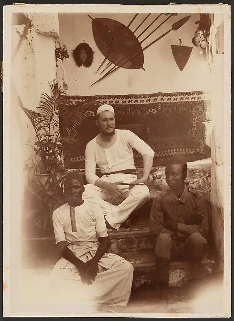 Oscar Baumann with two Africans inside a house
