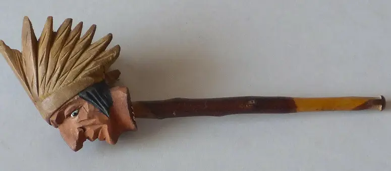 Tobacco pipe with carved American Indian face
