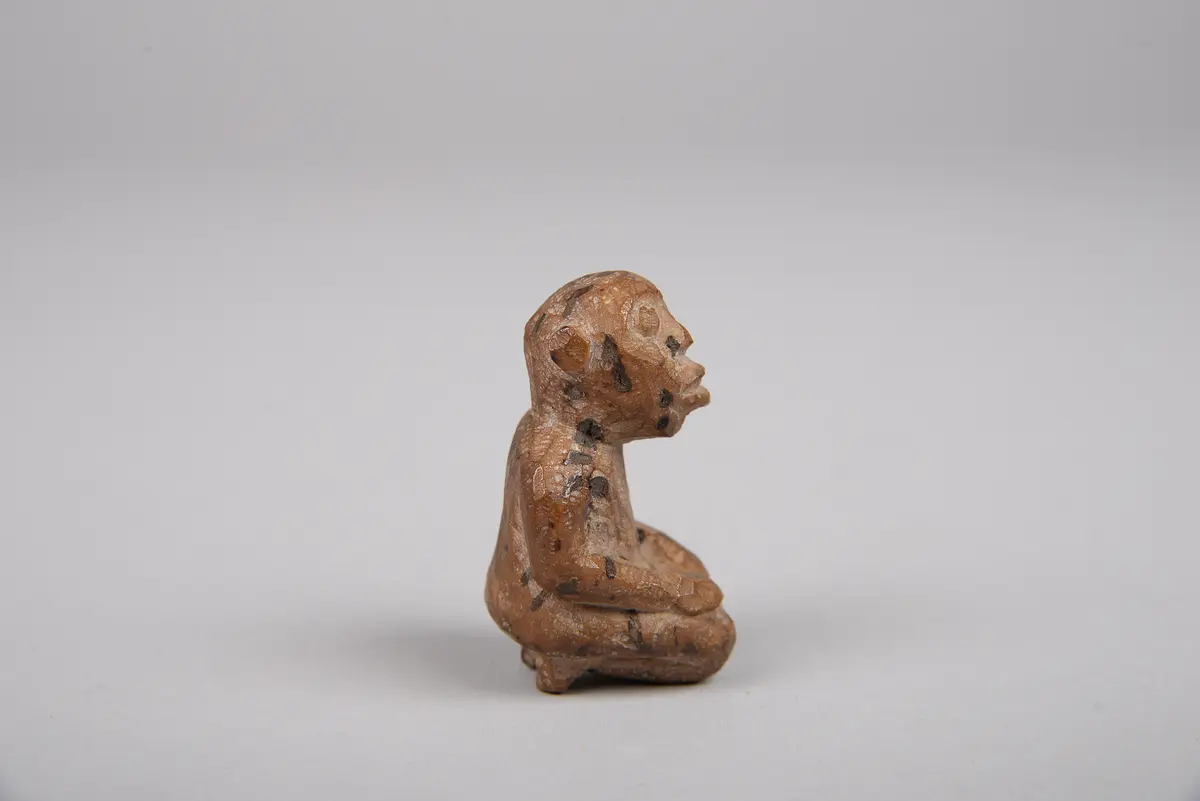 Knieende Figur