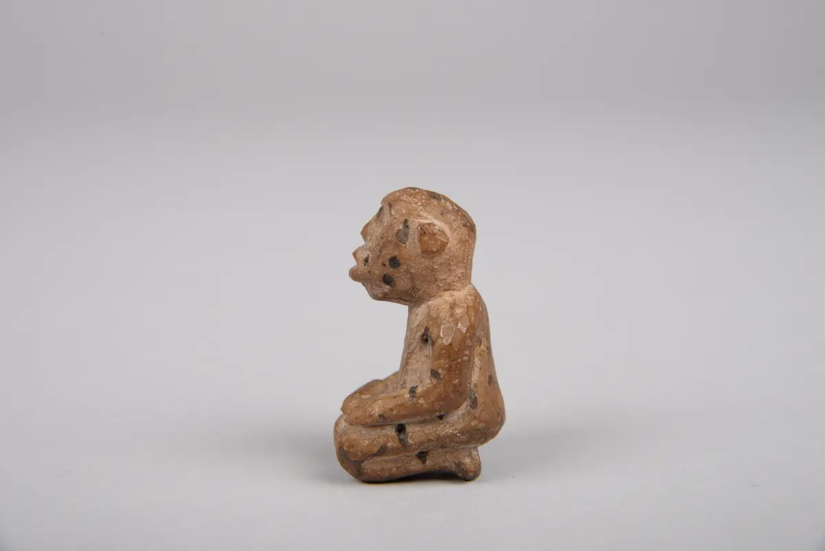 Knieende Figur