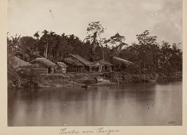Strohgedeckte Hütten an einem Gewässer bei Saigon