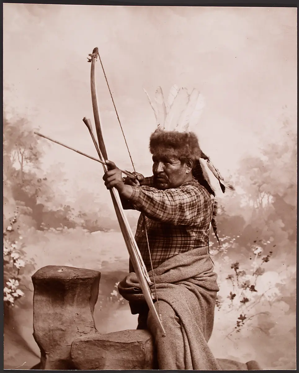 Anonymous man demonstrates how to use his bow and arrow
